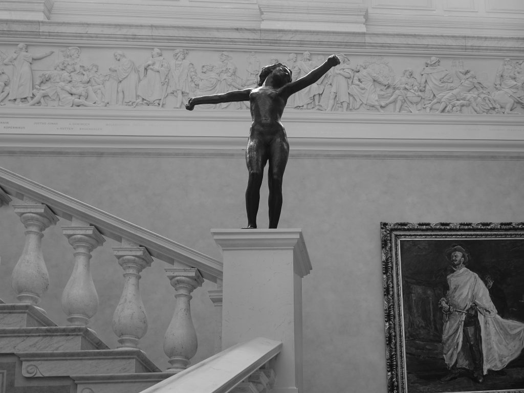 A classical sculpture on a museum facade, in black and white