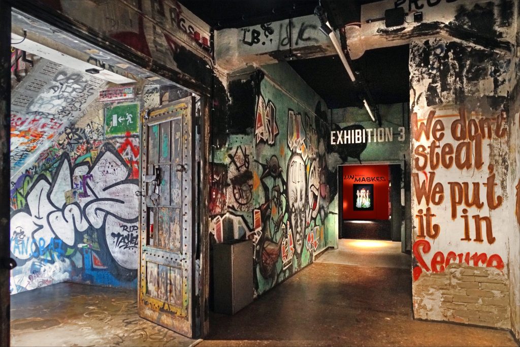 The interior of a street-art exhibition with graffiti-covered walls