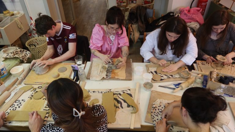A group of people in a hand-building pottery workshop