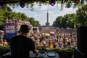 DJ performing from a music truck during the Rave the Planet Berlin 2026 parade in Berlin.